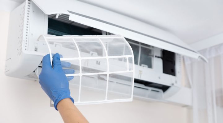 technician performing deep cleaning on a ductless mini-split indoor heat pump unit