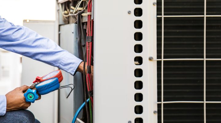 technician tuning up a heat pump system to optimize performance and energy efficiency