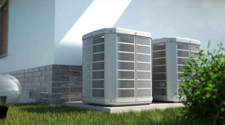 A white ducted HVAC system installed outdoors, delivering conditioned air through a network of ducts.